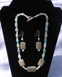 Designs by Adrienne created this African Opal necklace and earring set that is accented with Amazonite gemstones and freshwater potato shaped pearls.